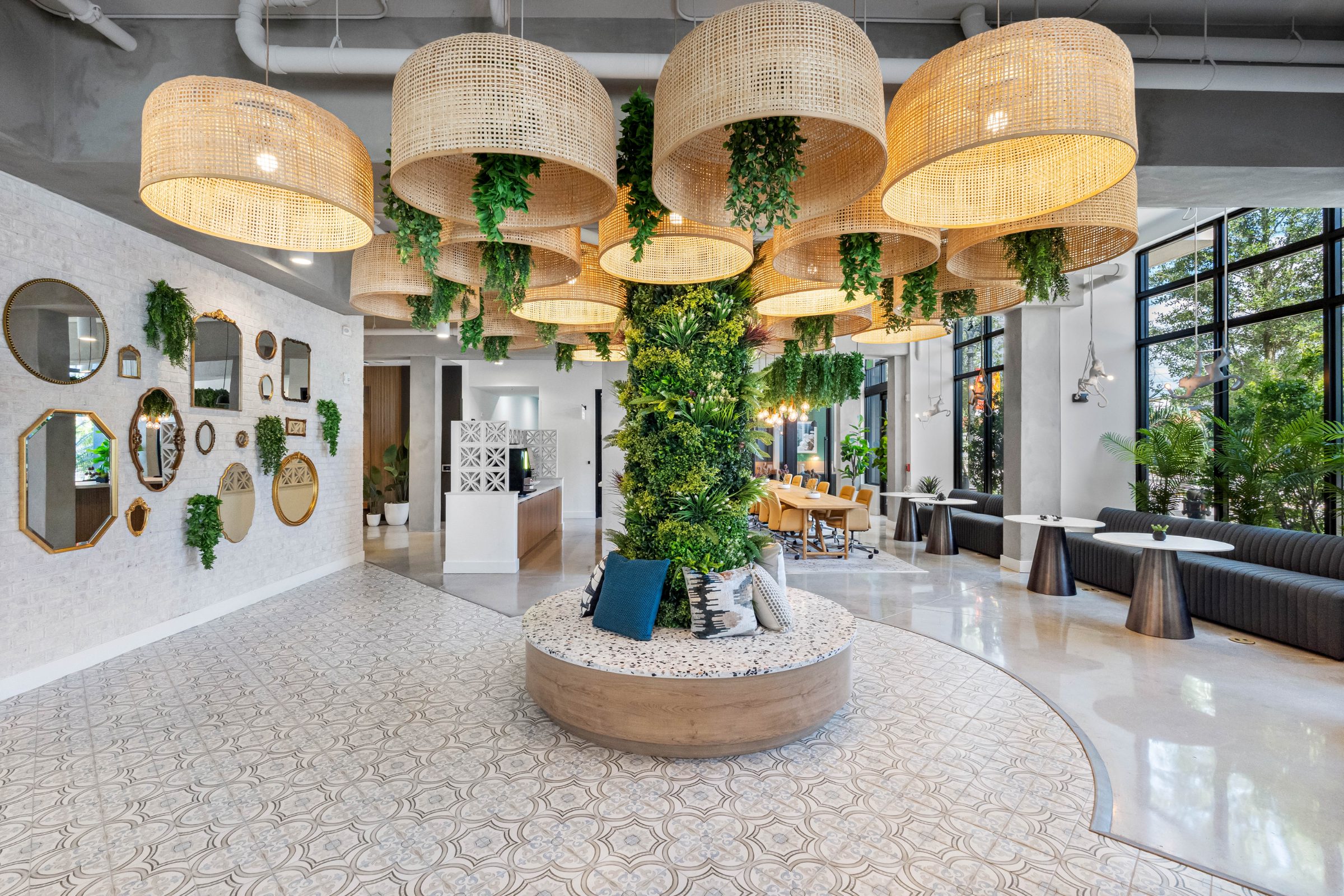 Resident lobby with rattan pendants and living green column at The Spruce